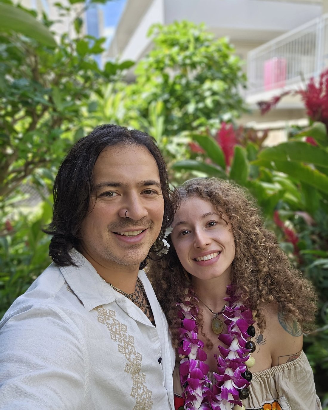 Suari and RoyDan smiling, wearing leis